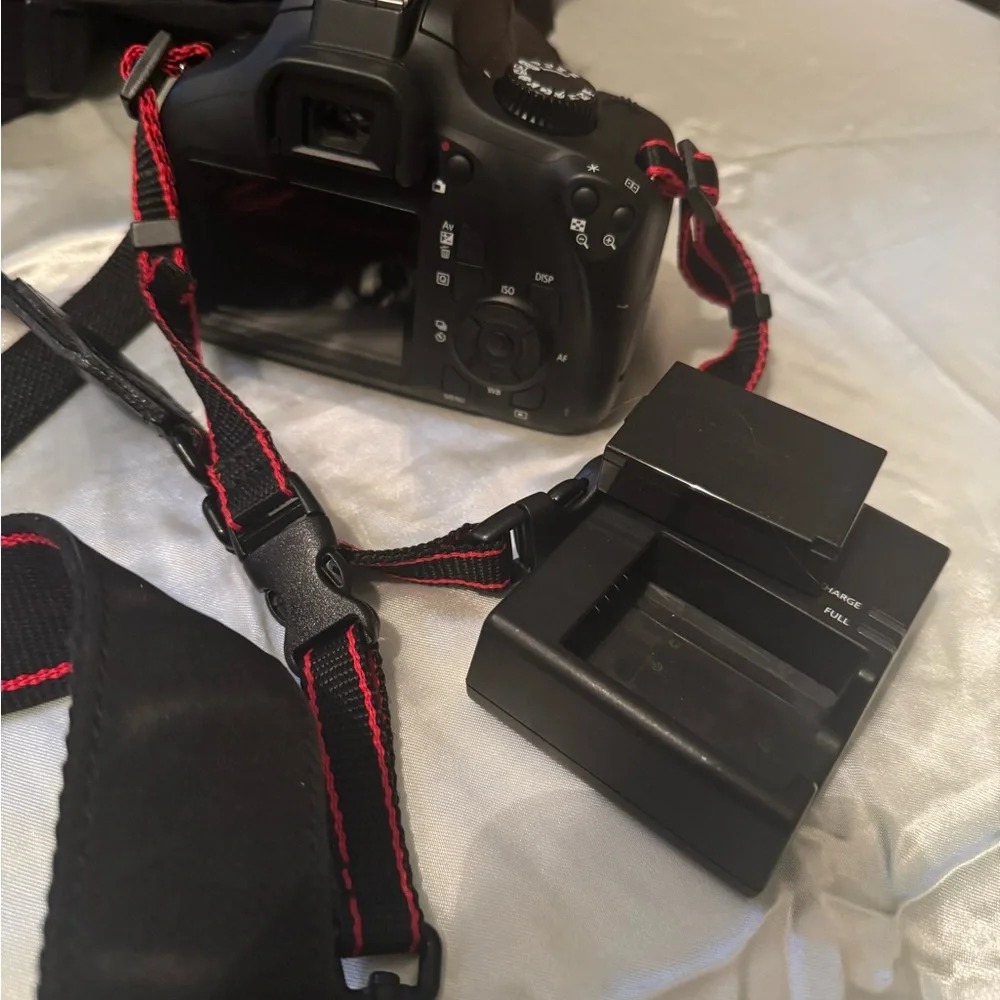 CANON EOS Rebel t100 with 18-55mm lens and another lens.